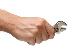 Adjustable wrench tool in hands on white isolate background photo