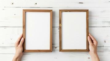 Hands Placing Blank Photo Frames on Wall for Mockup