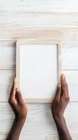 Hands Placing Blank Photo Frames on Wall for Mockup