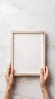Hands Placing Blank Photo Frames on Wall for Mockup