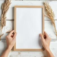 Hands Placing Blank Photo Frames on Wall for Mockup