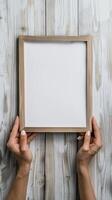 Hands Placing Blank Photo Frames on Wall for Mockup
