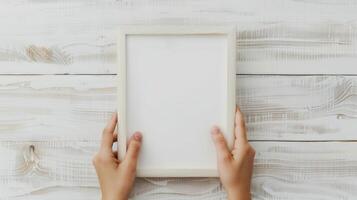 Hands Placing Blank Photo Frames on Wall for Mockup