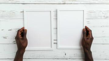 Hands Placing Blank Photo Frames on Wall for Mockup