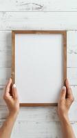 Hands Placing Blank Photo Frames on Wall for Mockup