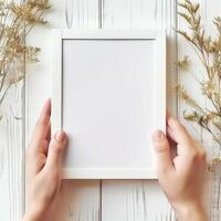 Hands Placing Blank Photo Frames on Wall for Mockup