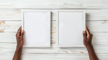 Hands Placing Blank Photo Frames on Wall for Mockup