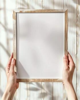 Hands Placing Blank Photo Frames on Wall for Mockup
