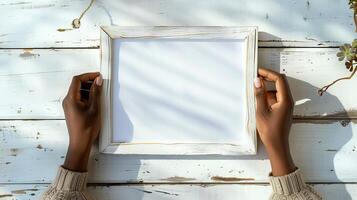 Hands Placing Blank Photo Frames on Wall for Mockup