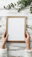Hands Placing Blank Photo Frames on Wall for Mockup