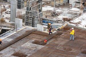 Managers, engineers discuss the further process of work on the construction site photo
