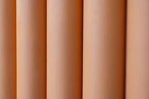 Vertical lines with a warm color palette. The colors transition smoothly from a light beige at the top to a deep. Background concept. photo