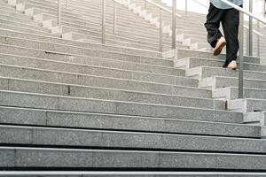 Abstract stairs in black and white, abstract steps, stairs in the city. A modern staircase with wide, smooth concrete steps and sleek stainless steel handrails. photo