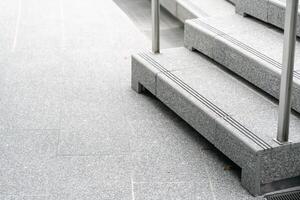 Abstract stairs in black and white, abstract steps, stairs in the city. A modern staircase with wide, smooth concrete steps and sleek stainless steel handrails. photo
