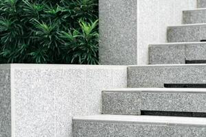 Abstract stairs in black and white, abstract steps, stairs in the city. A modern staircase with wide, smooth concrete steps and sleek stainless steel handrails. photo