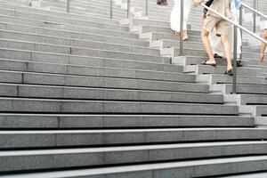 Abstract stairs in black and white, abstract steps, stairs in the city. A modern staircase with wide, smooth concrete steps and sleek stainless steel handrails. photo