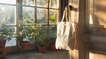 A clean reusable bag hanging on a doorknob in a sunlit room, ready for eco-friendly branding photo