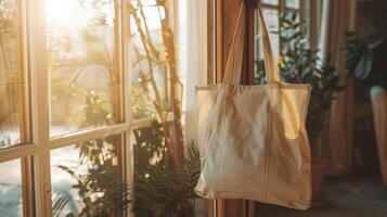 A clean reusable bag hanging on a doorknob in a sunlit room, ready for eco-friendly branding photo