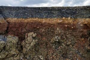 The curb erosion from storms. To indicate the layers of soil and rock. photo