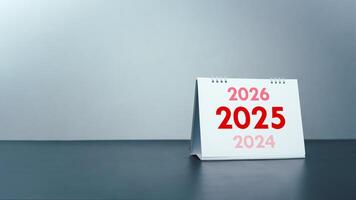 2025 Happy New year background, Setup objective target business cost and budget planning of new year concept, Year change from 2024 to 2025, Turns over a white calendar sheet. photo