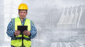 Engineer working with tablet with double exposure background of clean energy power generation source. Engineer inspecting power control. Wind farm produces electricity with alternative green energy. photo