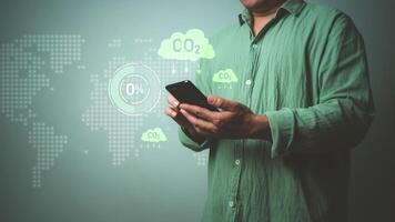 Carbon reduction and carbon credit to limit global warming from climate change, Businessman using phone and showing Co2 reduction symbol, Bio Circular Green Economy concept, Greenhouse gas, Net zero. photo
