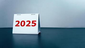2025 Happy New year background, Setup objective target business cost and budget planning of new year concept, Year change from 2024 to 2025, Turns over a white calendar sheet. photo