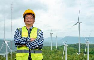 Picture of One Engineer working at windmill farm Generating electricity clean energy. Wind turbine farm generator by alternative green energy. Engineer checking control electric power. photo