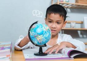 Kid Education, Asian boy looking at globe find the location of countries in the world, Concept for research global warming, global network, SEO search engine, Save the Earth, Ecology. photo