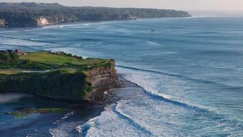 Bali coastline with ocean and perfect swell waves. Drone view of scenic seascape video
