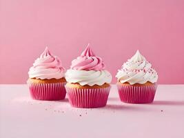 Delicious cute cupcakes on pink background photo