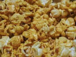 Delicious sweet popcorn, close-up shot for dessert food background. photo
