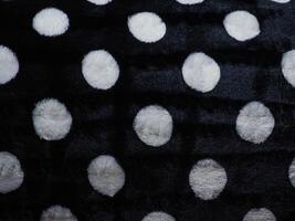 White polka dot carpet texture on black for background. photo