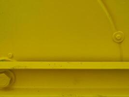 Yellow painted steel texture for a close-up background of a building or construction. photo
