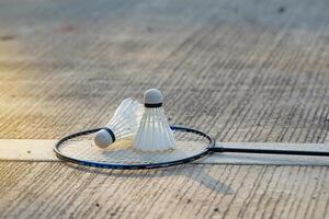 Badminton racket and white shuttlecock placed on cement background. soft and selective focus. photo
