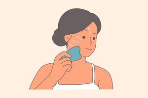 Woman makes facial massage to rejuvenate and get rid of wrinkles using gua sha device vector