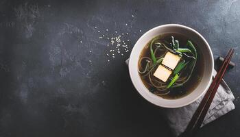 Miso Soup with Tofu and Scallions on Dark Background photo