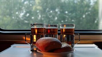Buns and tea in glasses on a table in a compartment carriage video