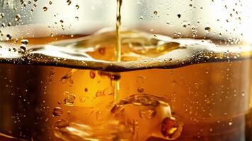 An upclose view of apple cider splashing over the edges of a classic mason jar.. video
