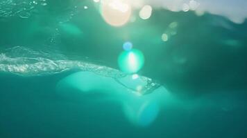 Closeup of a lone wave rushing towards the camera creating a mesmerizing swirling effect with its turquoise hues.. video