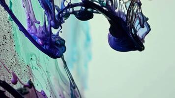 Detailed closeup of acrylic paint being dripped and swirled together on a canvas revealing intricate patterns.. video