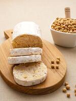 Raw Tempeh or Tempe, Indonesian traditional food, made from fermented soybeans. Usually fried for a side dish or for other cooking ingredients. photo