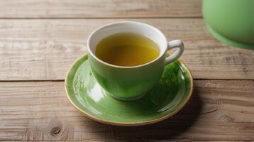 green tea in a cup on a wooden table photo