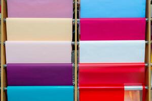 Multicolored rolls of wrapping paper on the showcase. Abstract background. photo