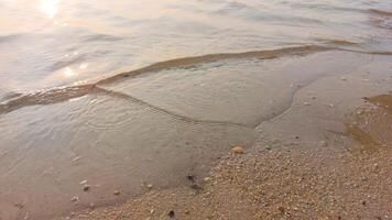 Close up soft wave lapped the sandy beach. natural abstract background and texture photo