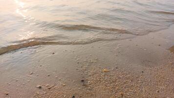Close up soft wave lapped the sandy beach. natural abstract background and texture photo