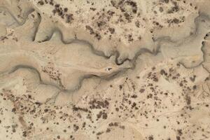 Aerial view of a man lying on the ground in the Abanilla desert or Mahoya desert in Murcia. photo