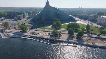 Aerial view of the construction works near National Library in Riga Latvia. Rebuilding the river bank and sidewalks for the residential area. Building pedestrian roads and waterfront with a Riga view. video