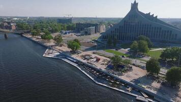 Aerial view of the construction works near National Library in Riga Latvia. Rebuilding the river bank and sidewalks for the residential area. Building pedestrian roads and waterfront with a Riga view. video