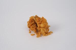 Golden brown fried chicken on white background. Fried chicken isolated over white. Fried chicken isolated on white background. Crispy fried chicken pieces in mid-air with crumbs scattering isolated photo